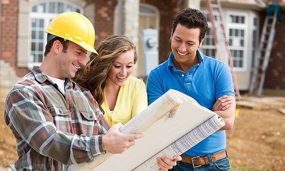 Team members discussing iron door with homeowners