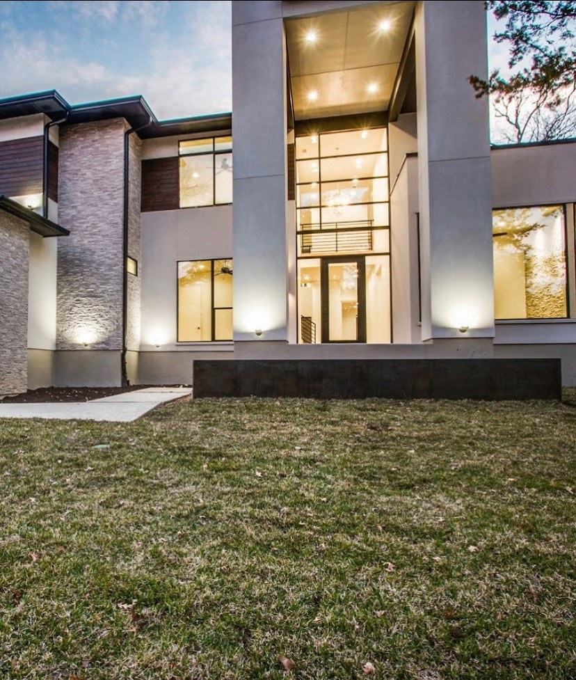 Beautiful modern home with large windows and black iron front door