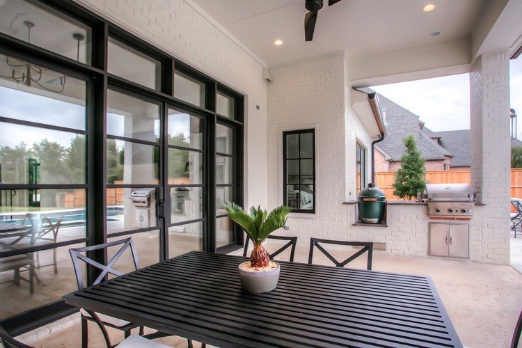 Black finish iron double doors leading to patio