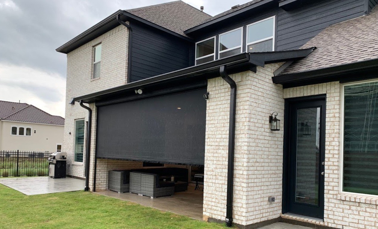 Outdoor living space enclosed by patio shade