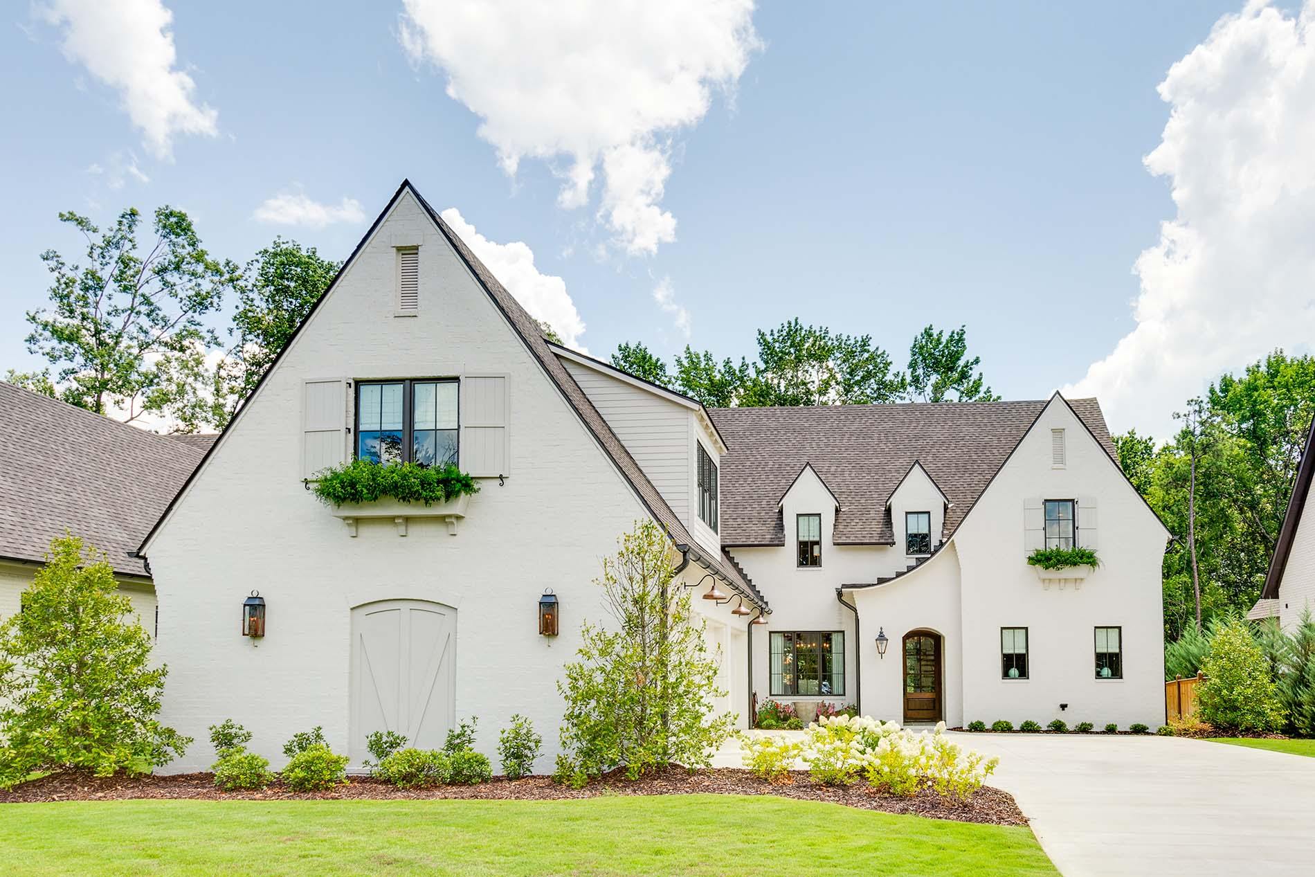 White stucco home with brand new windows