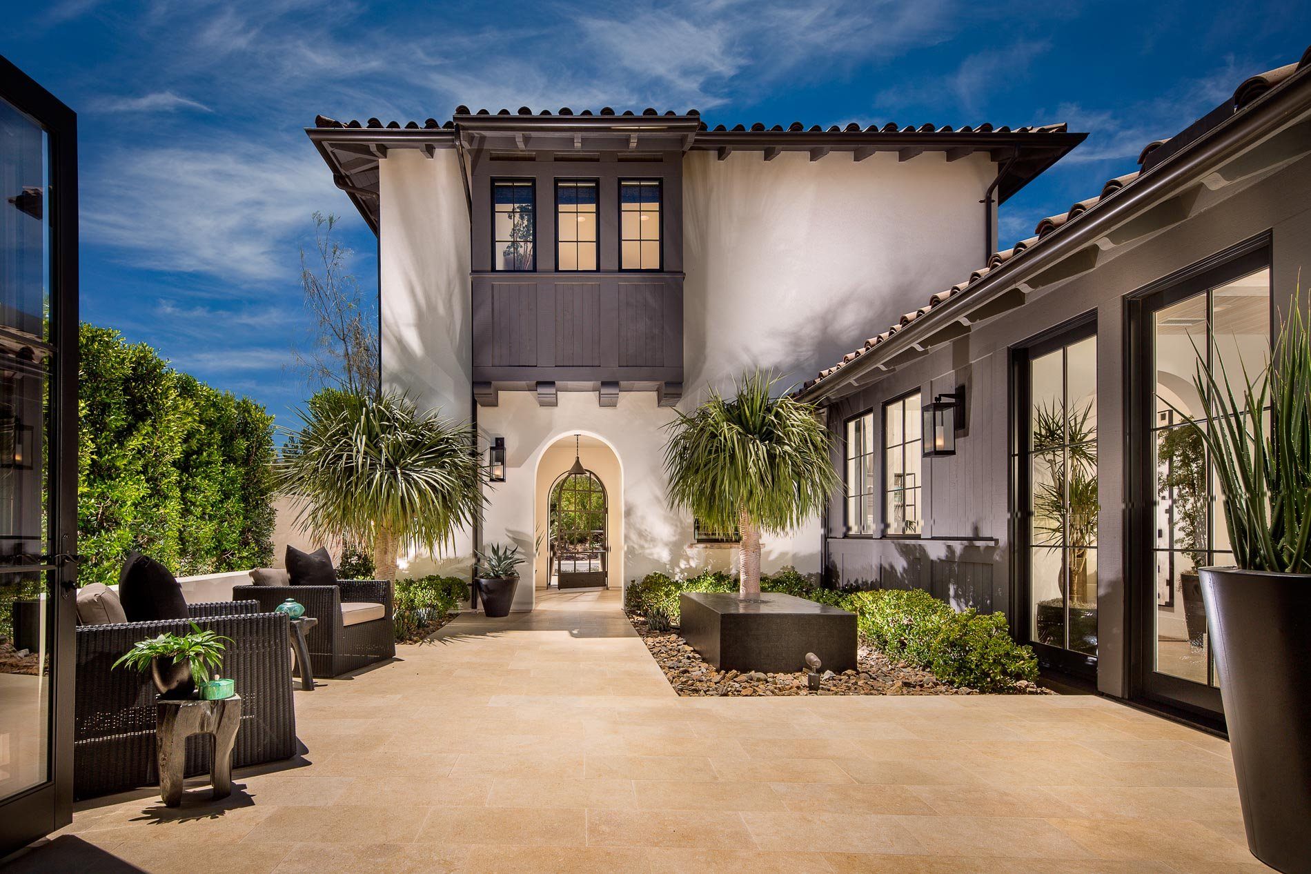 Gorgeous outdoor patio area looking onto home with replacement windows and juliet balcony