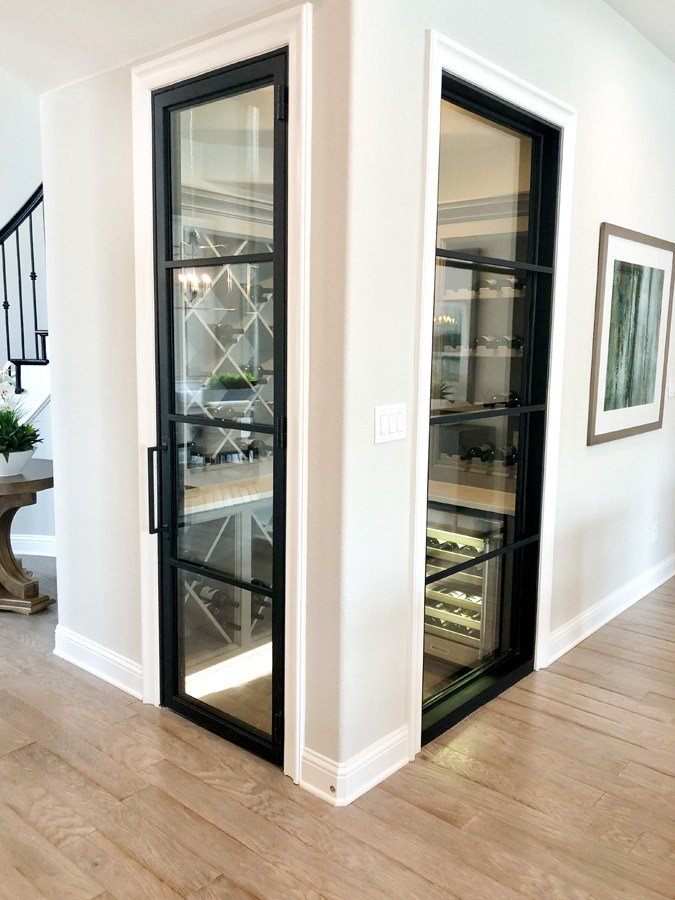 Wine cellar with glass and iron doors on two sides